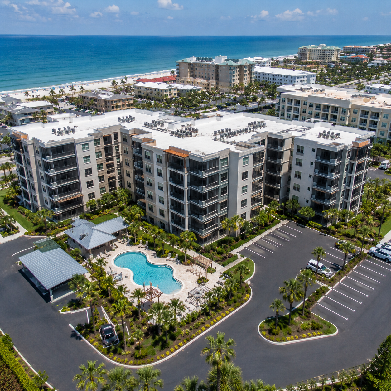 Aerial view of a large coastal condominium and resort property